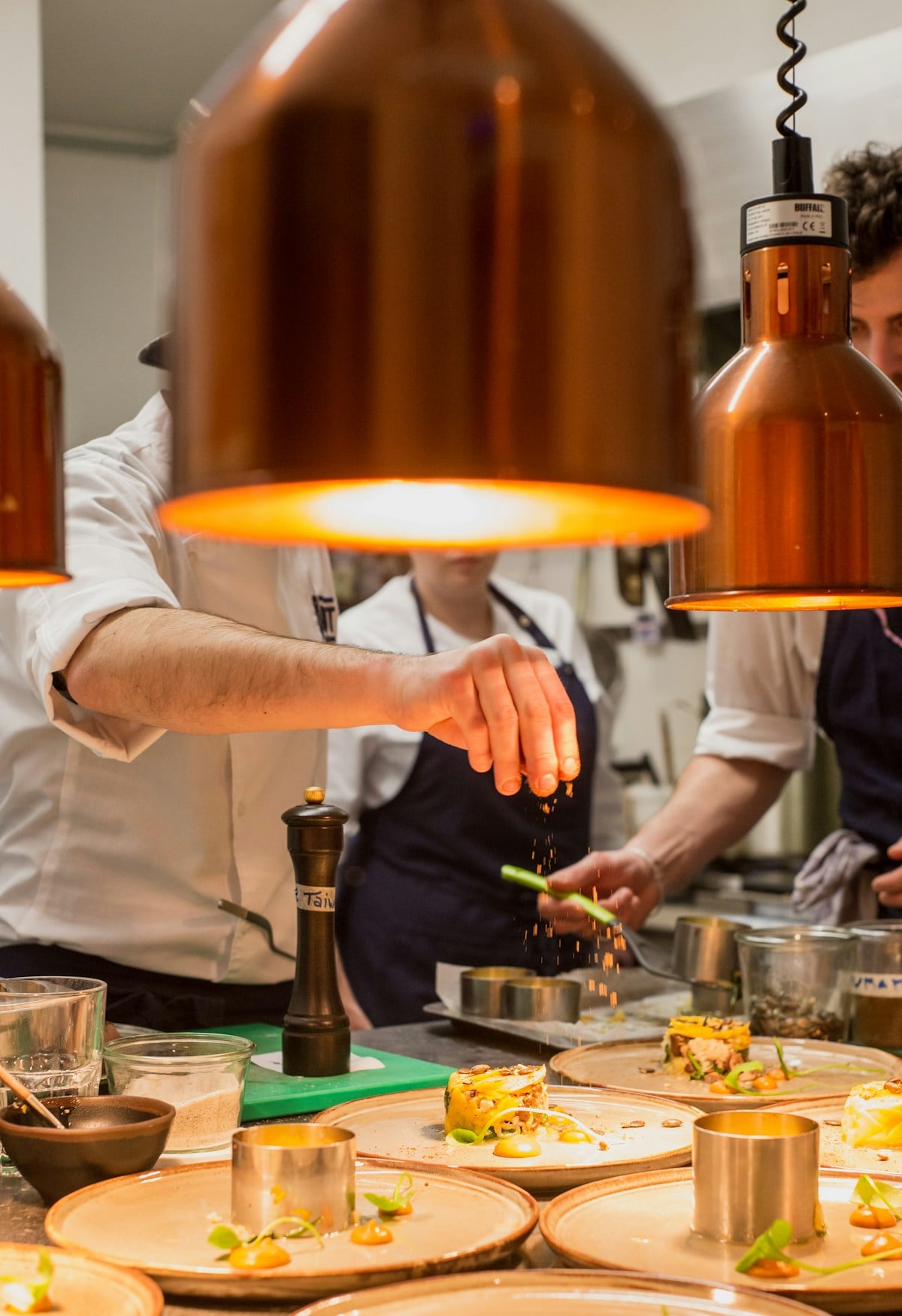 A chef putting the final touches on an elegant dish